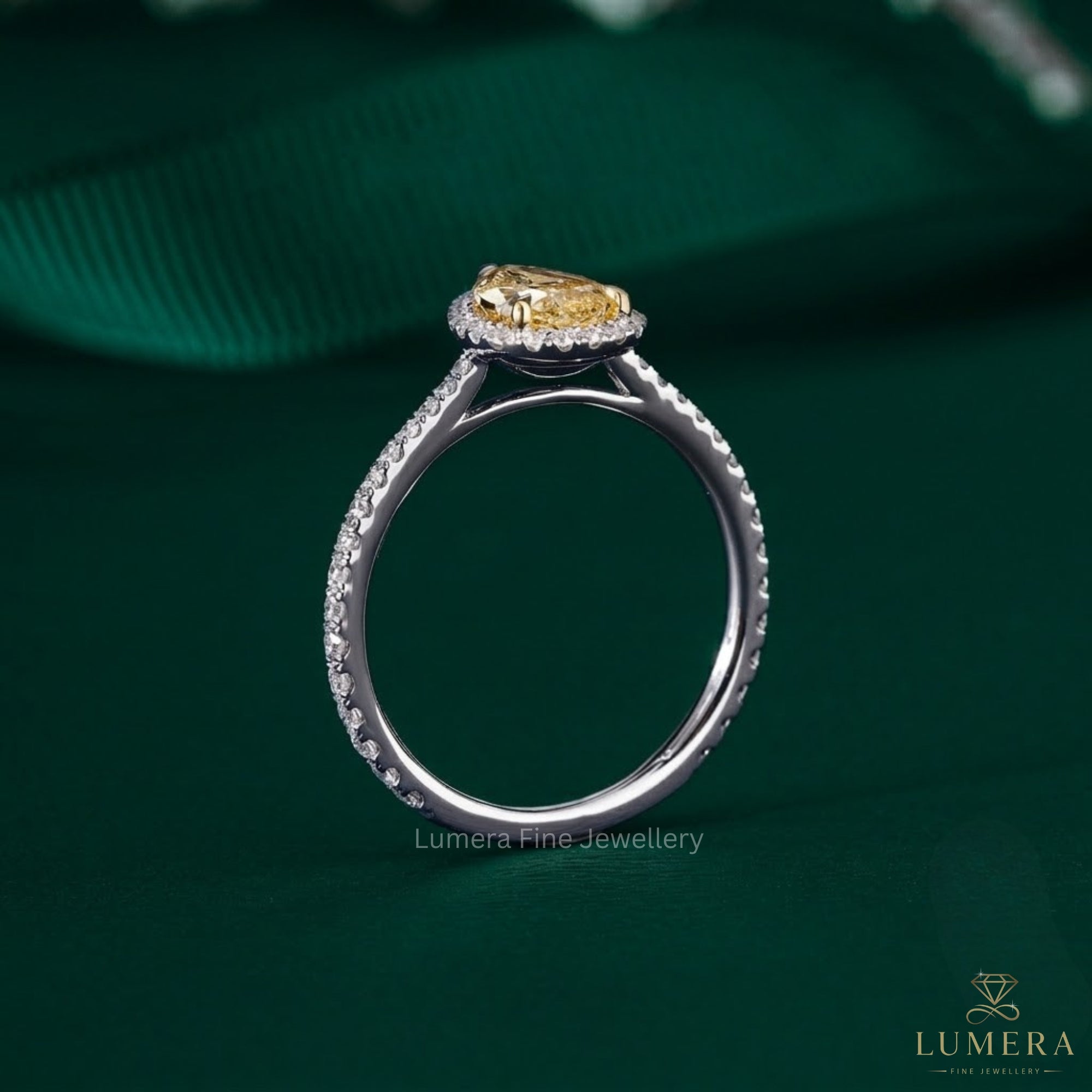 pear shape halo engagement ring with V prong setting.