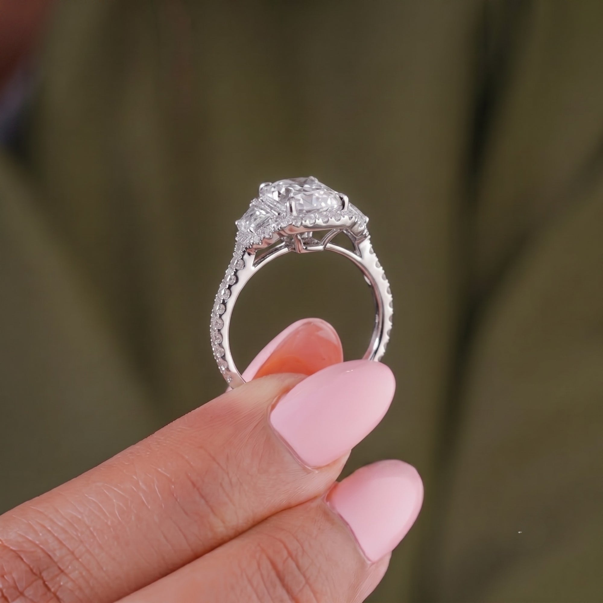 4 claw prong ring with three stone engagement ring.

