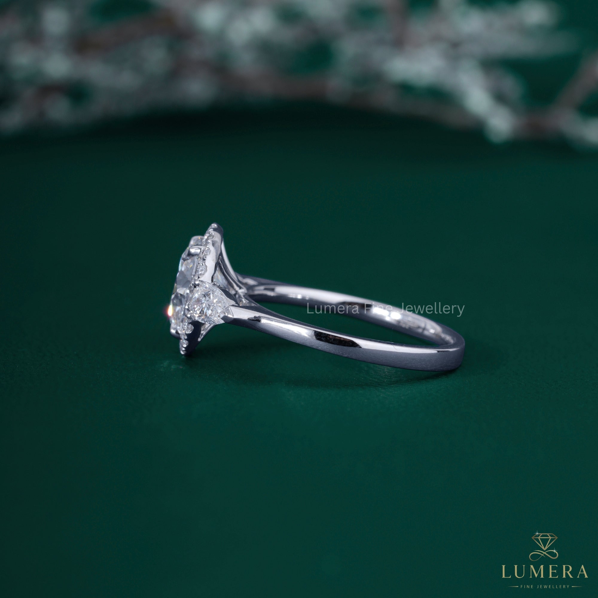 Halo diamond ring with 4 claw prong setting.