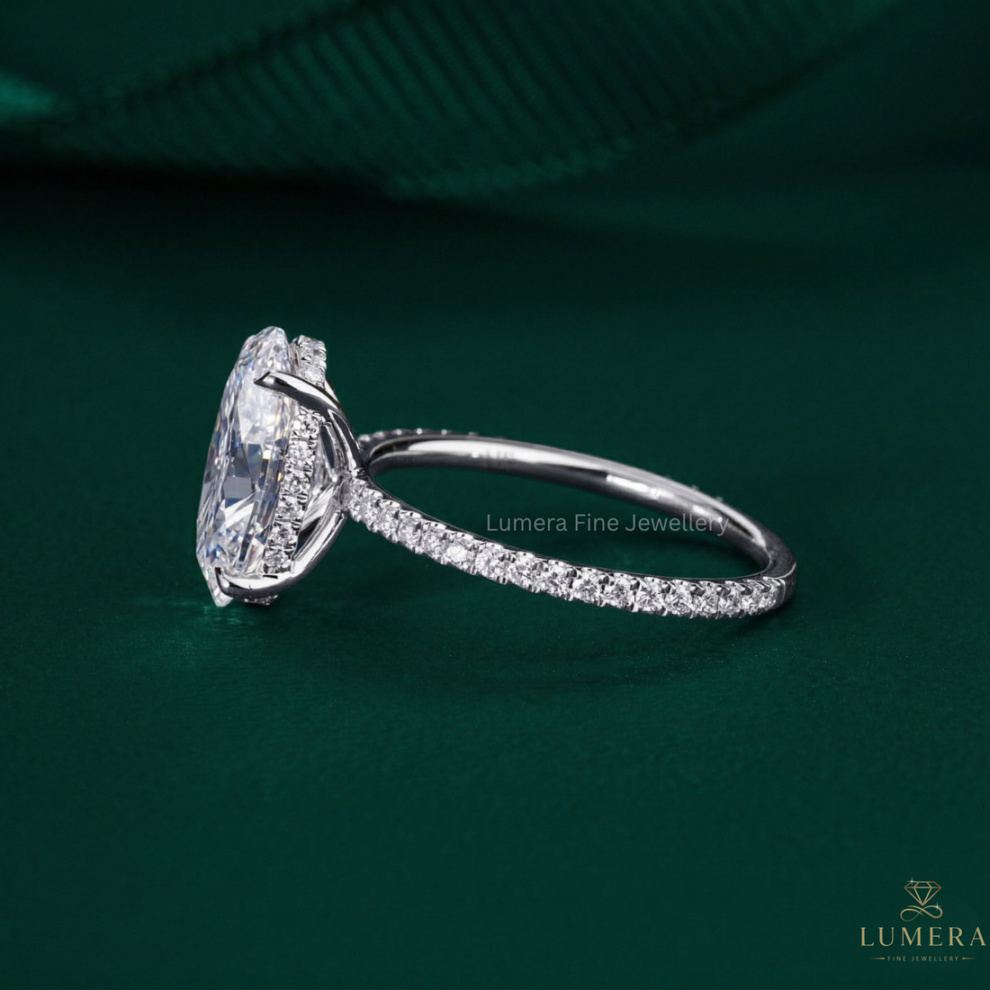 oval cut engagement ring on pave set band ring.
