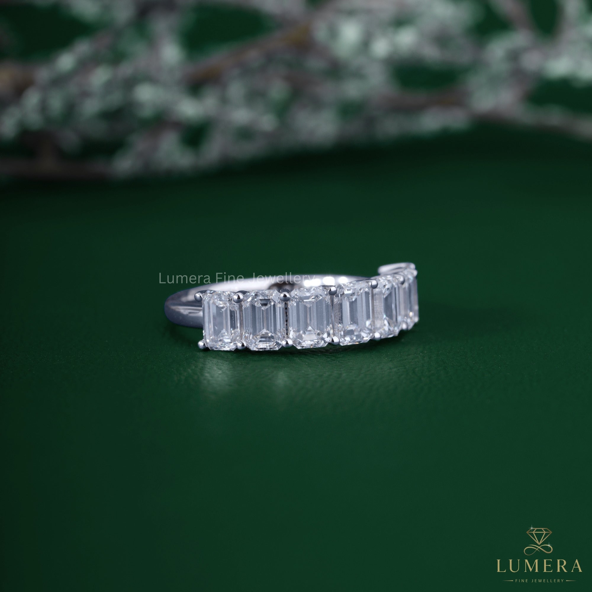 Half eternity wedding band with emerald eternity band.