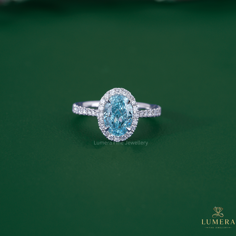 Blue diamond engagement ring with cathedral setting ring.