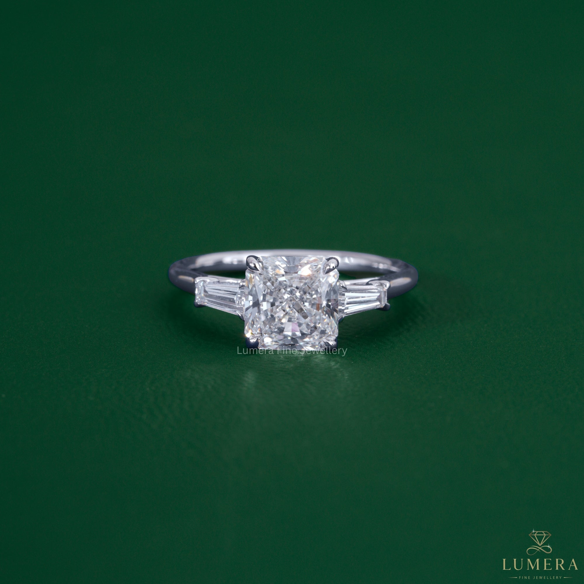 Square radiant diamond engagement ring featuring tapered baguette side stones.
