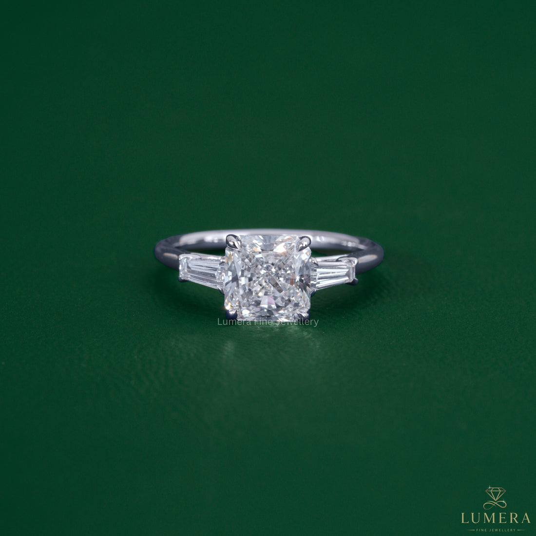 Square radiant diamond engagement ring featuring tapered baguette side stones.