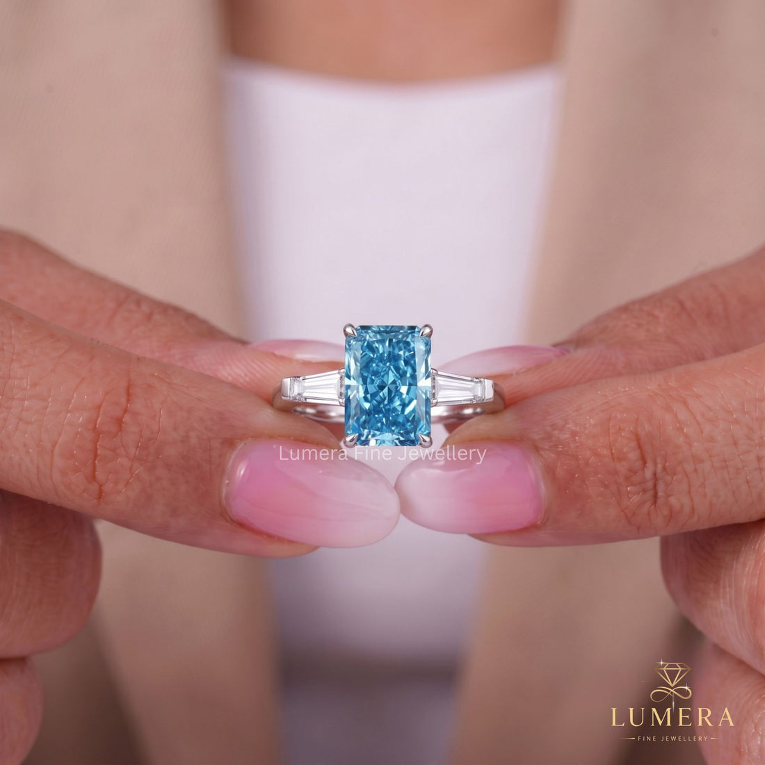 Blue diamond ring with radiant cut engagement ring.
