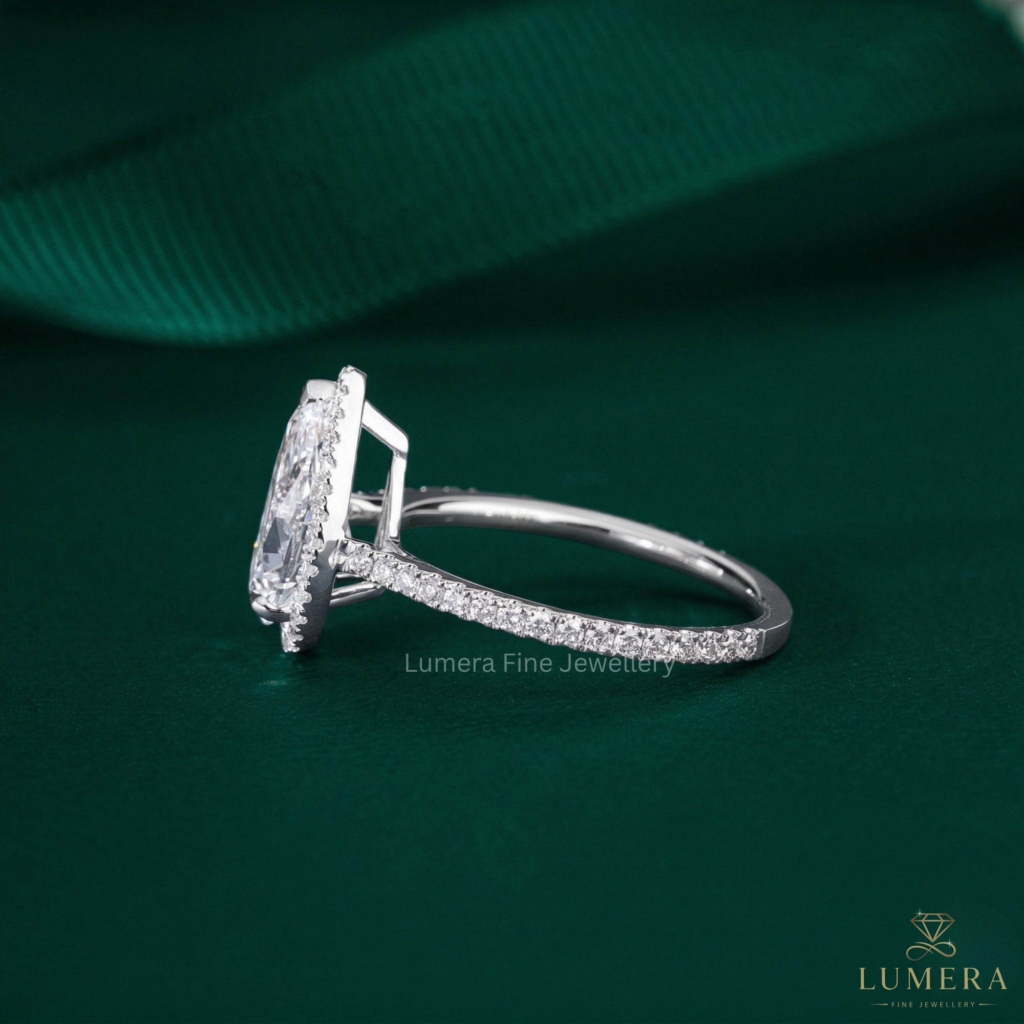 pear cut halo diamond ring with V prong setting.
