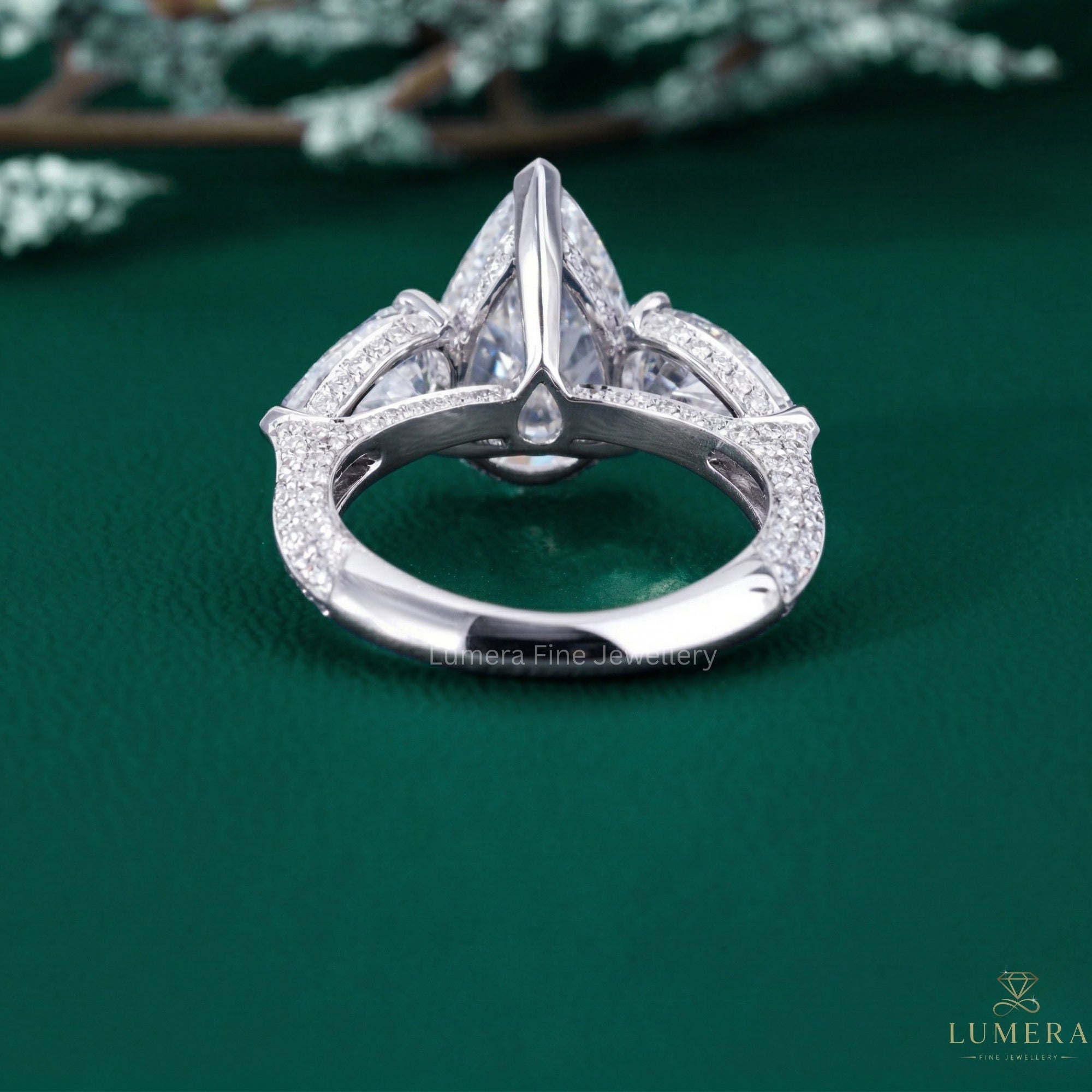pear side stones with hidden halo engagement ring.