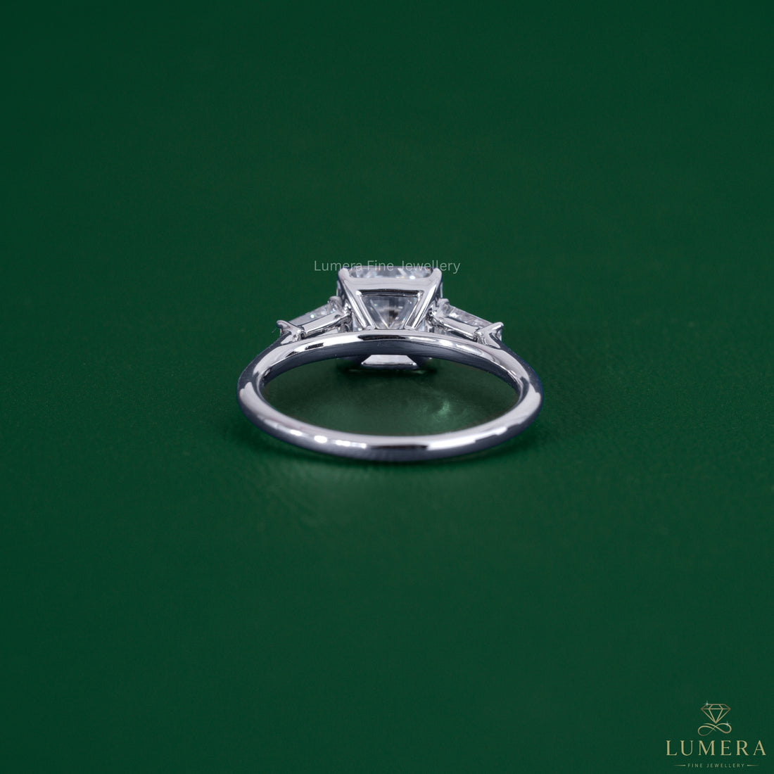 Tapered baguette side stones beside a square radiant cut ring.