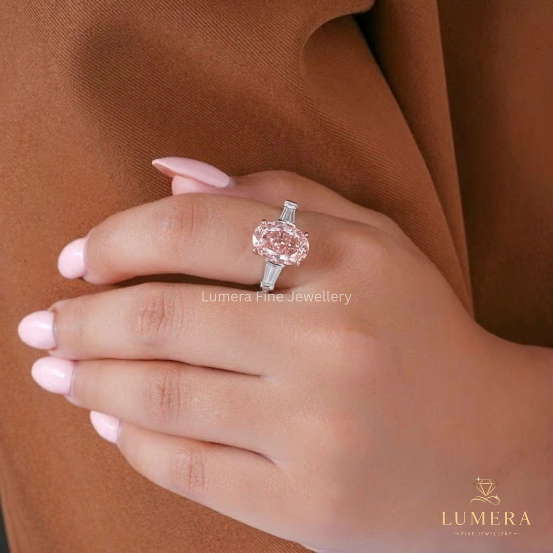 Pink diamond ring featuring an oval cut engagement ring.
