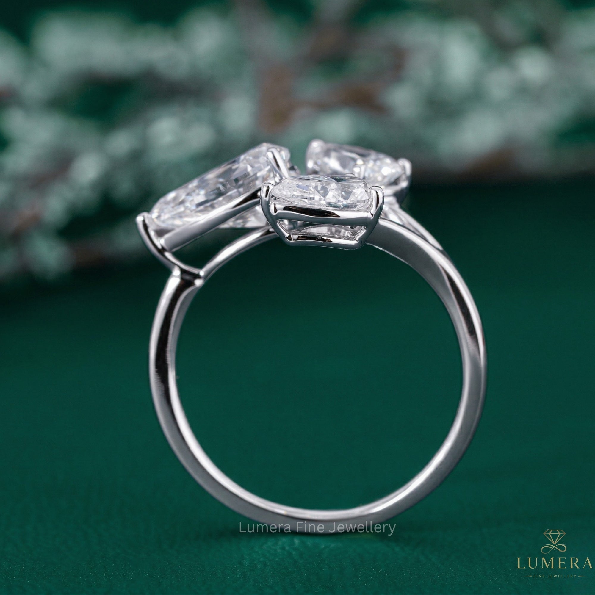 three stone engagement ring with three stone pear ring.