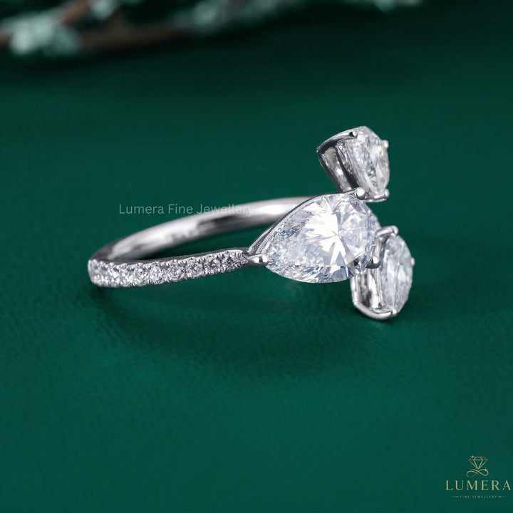 3 stone ring with pear diamond engagement ring.