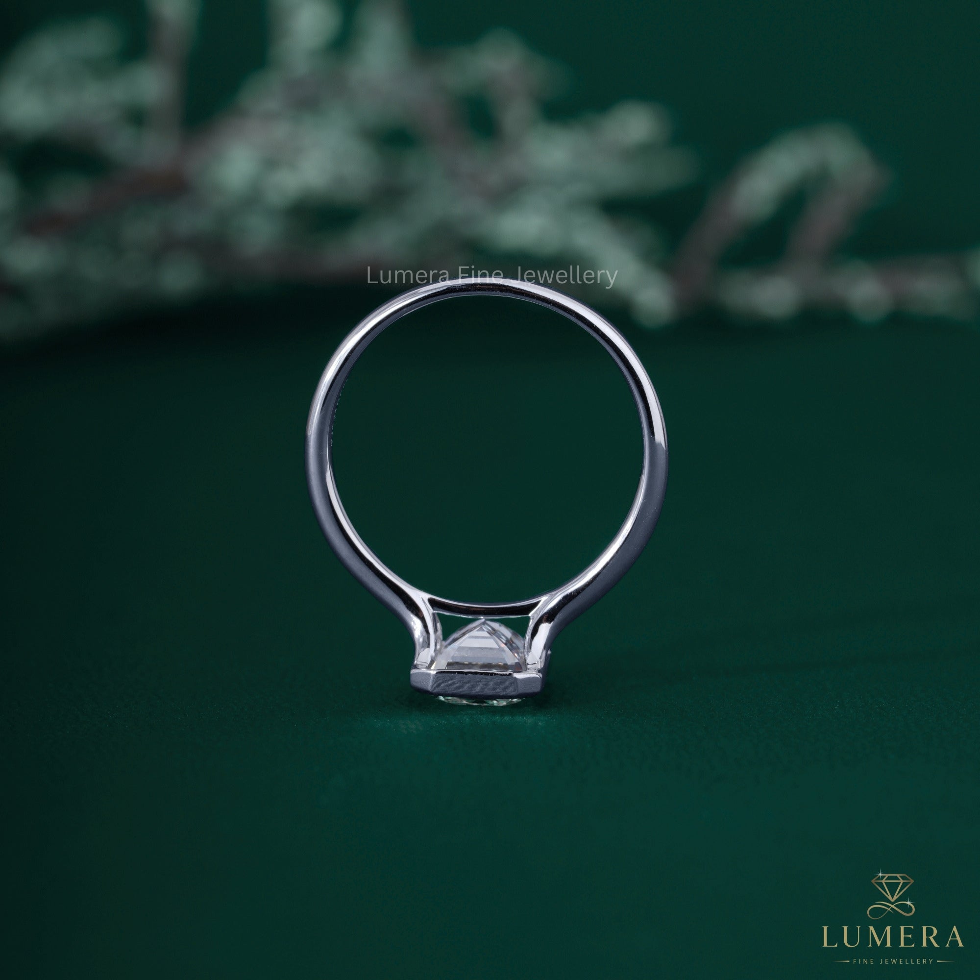 Split shank engagement ring with bezel setting ring.