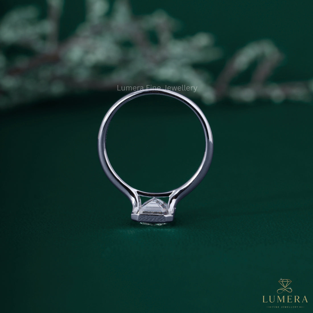 Split shank engagement ring with bezel setting ring.