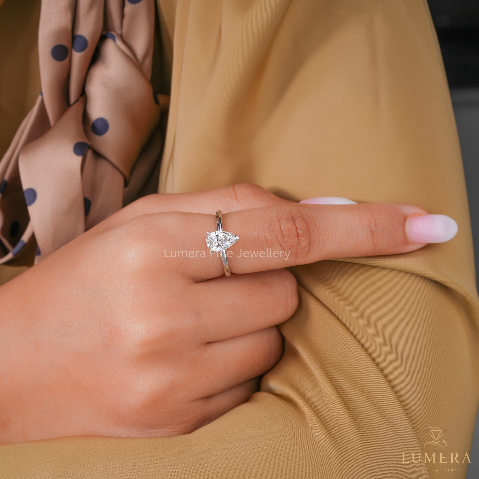 Pear Solitaire Ring with customized ring.
