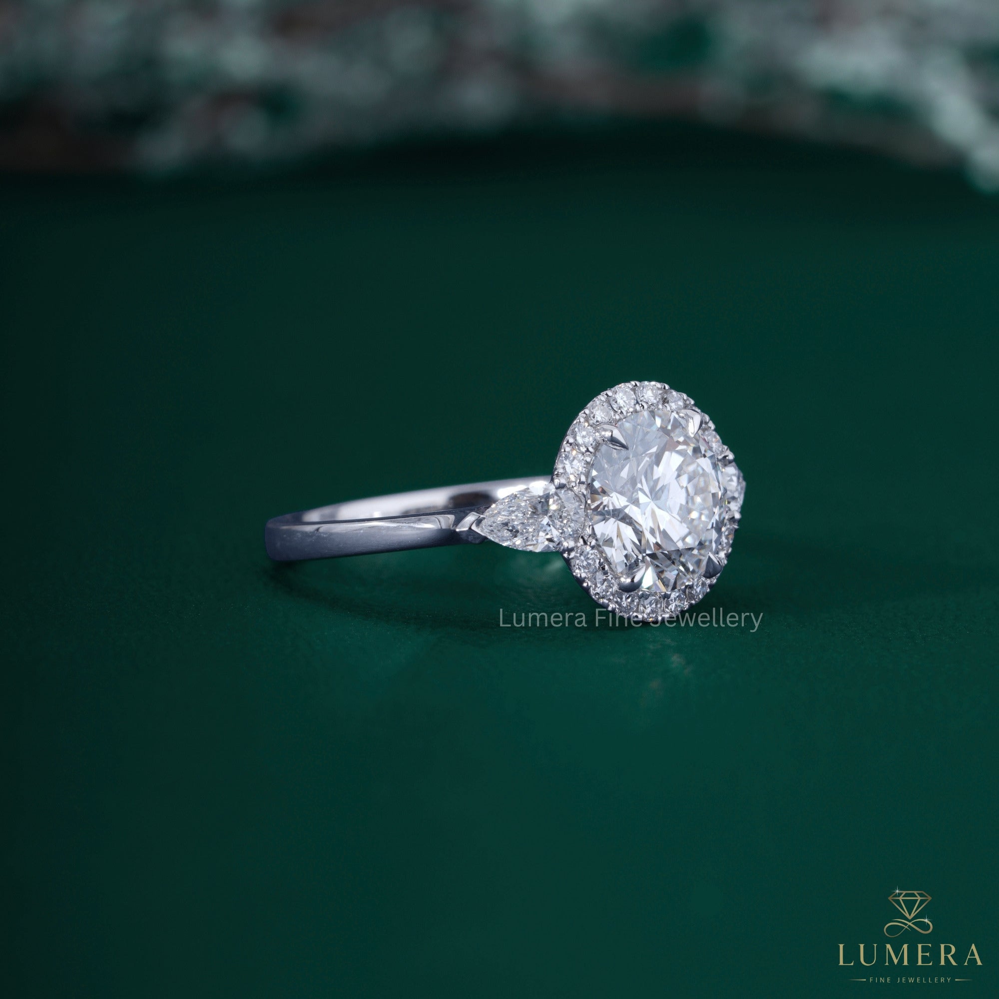 Round cut halo ring with three stone engagement ring.