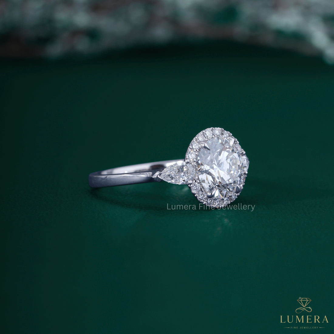 Round cut halo ring with three stone engagement ring.
