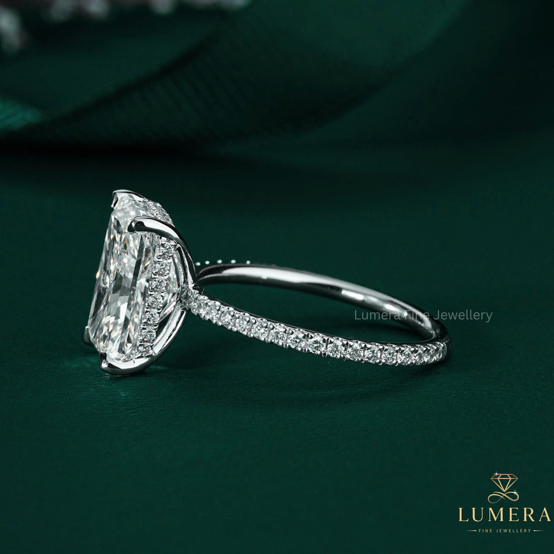 radiant cut engagement ring on hidden halo ring.
