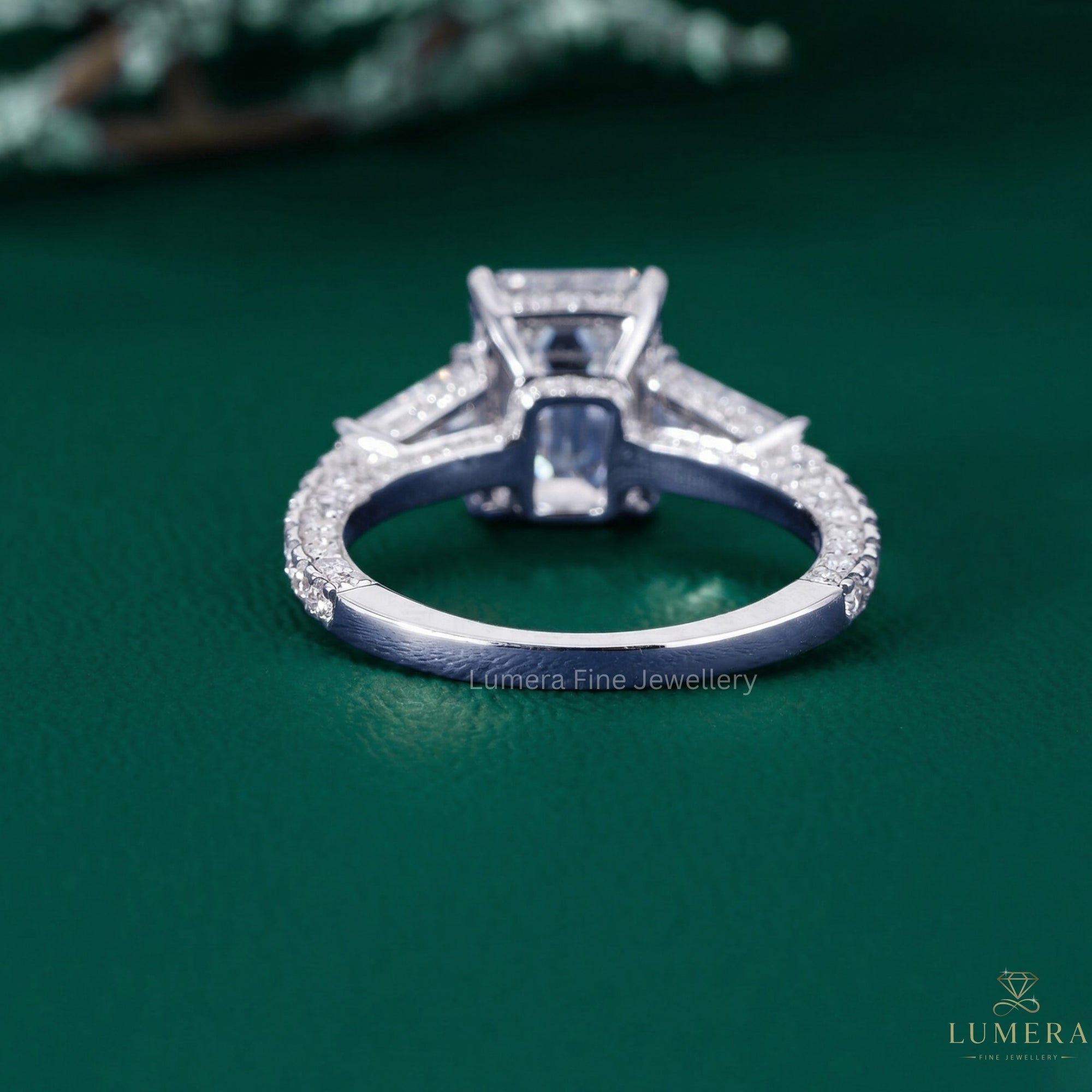 three stone emerald cut engagement ring with tapered baguette side stone.