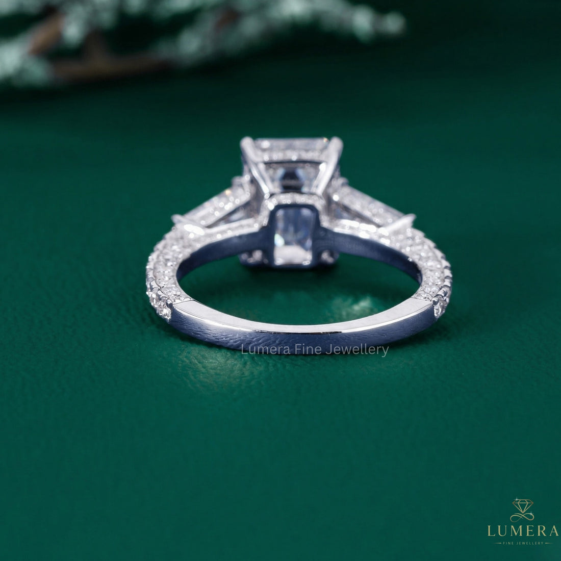 three stone emerald cut engagement ring with tapered baguette side stone.