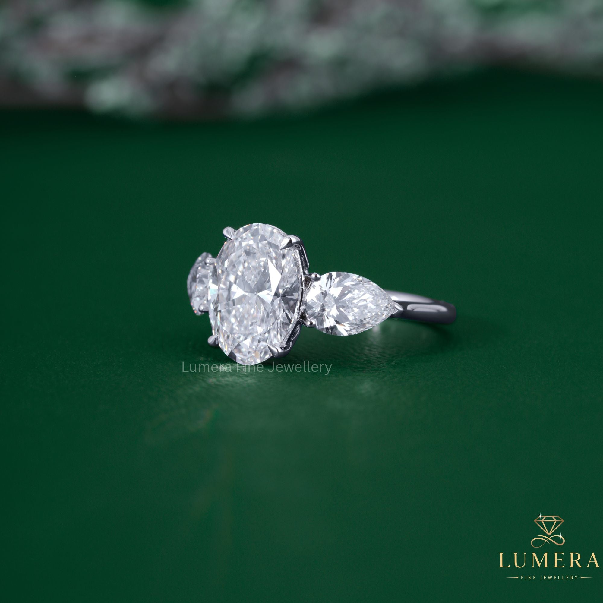 Pear side stone with oval and pear diamond ring.
