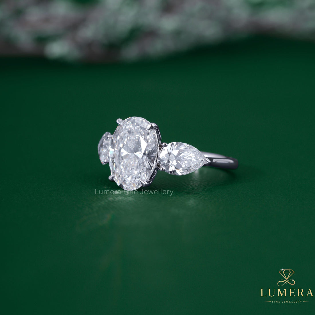 Pear side stone with oval and pear diamond ring.