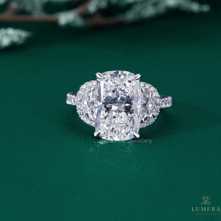 cushion diamond cut ring with half moon cut side stones.