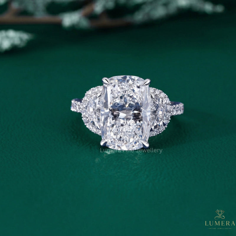 cushion diamond cut ring with half moon cut side stones.