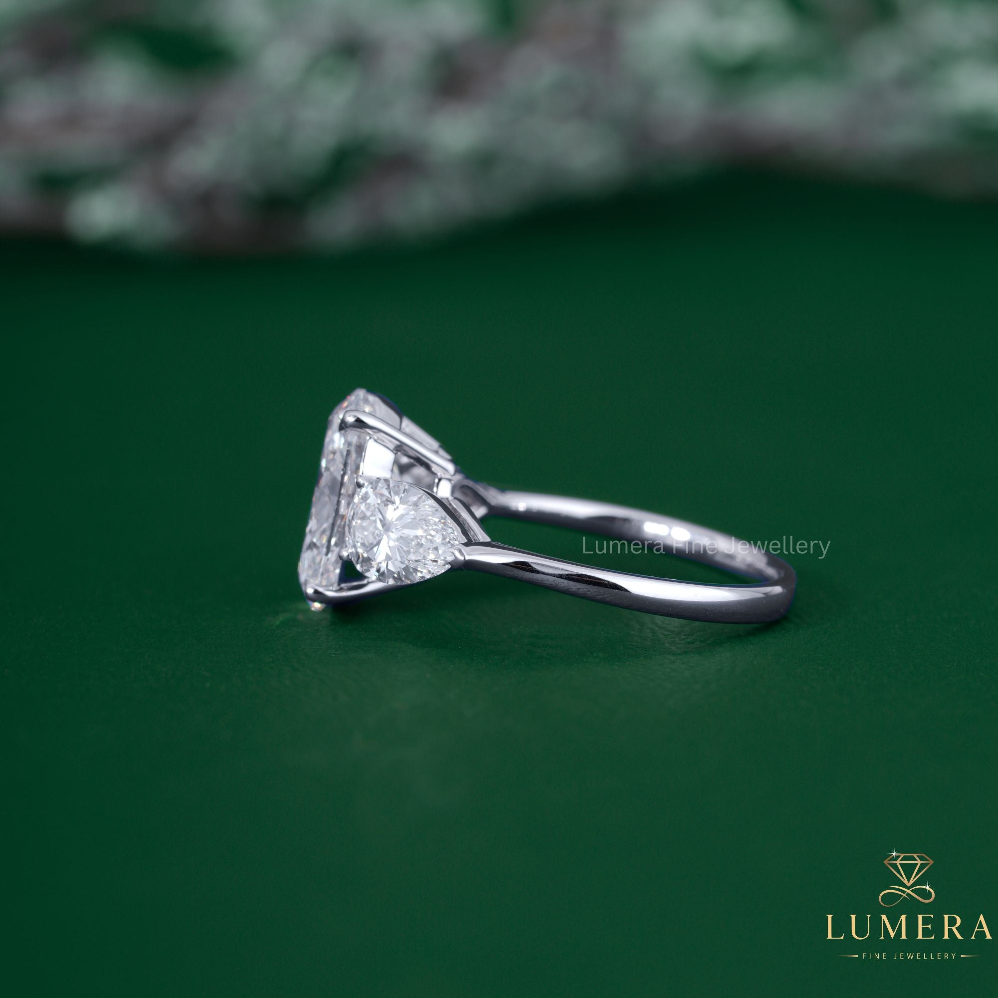 3 stone diamond engagement ring with claw prong setting.