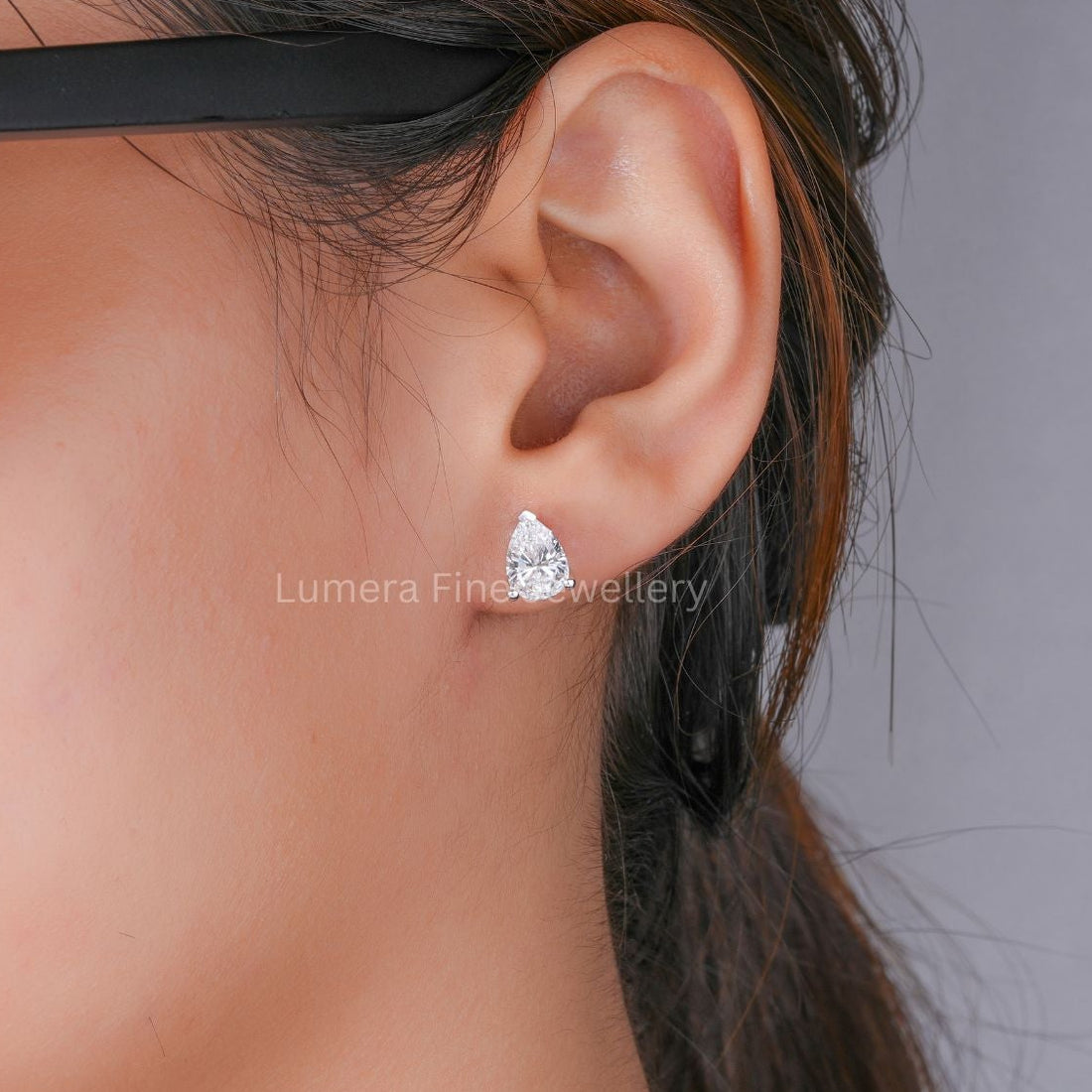 lumera earrings with pear diamond solitaire earring.
