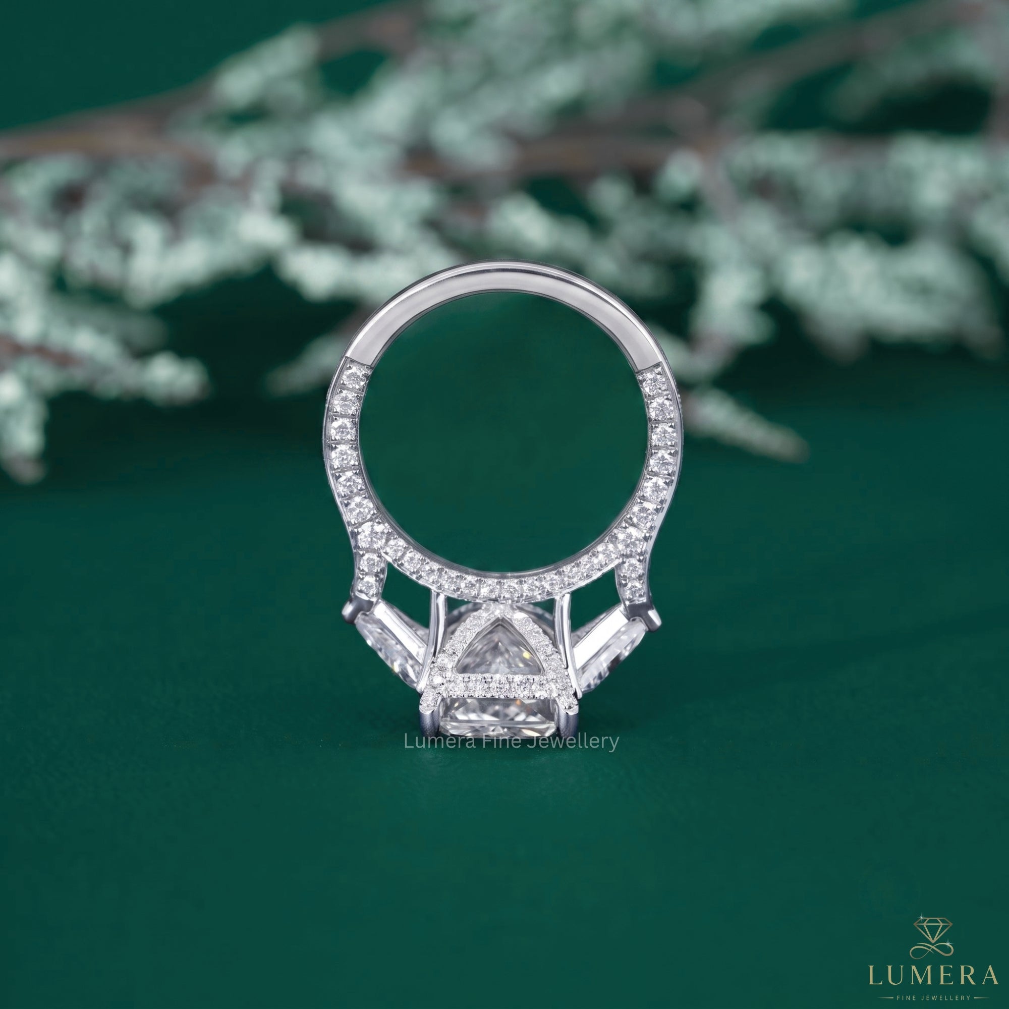 Three stone diamond ring with tapered shank setting.