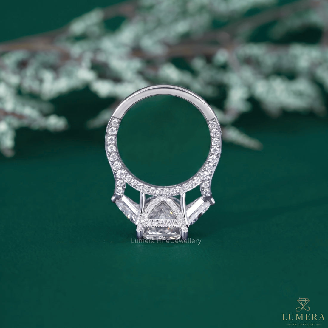 Three stone diamond ring with tapered shank setting.