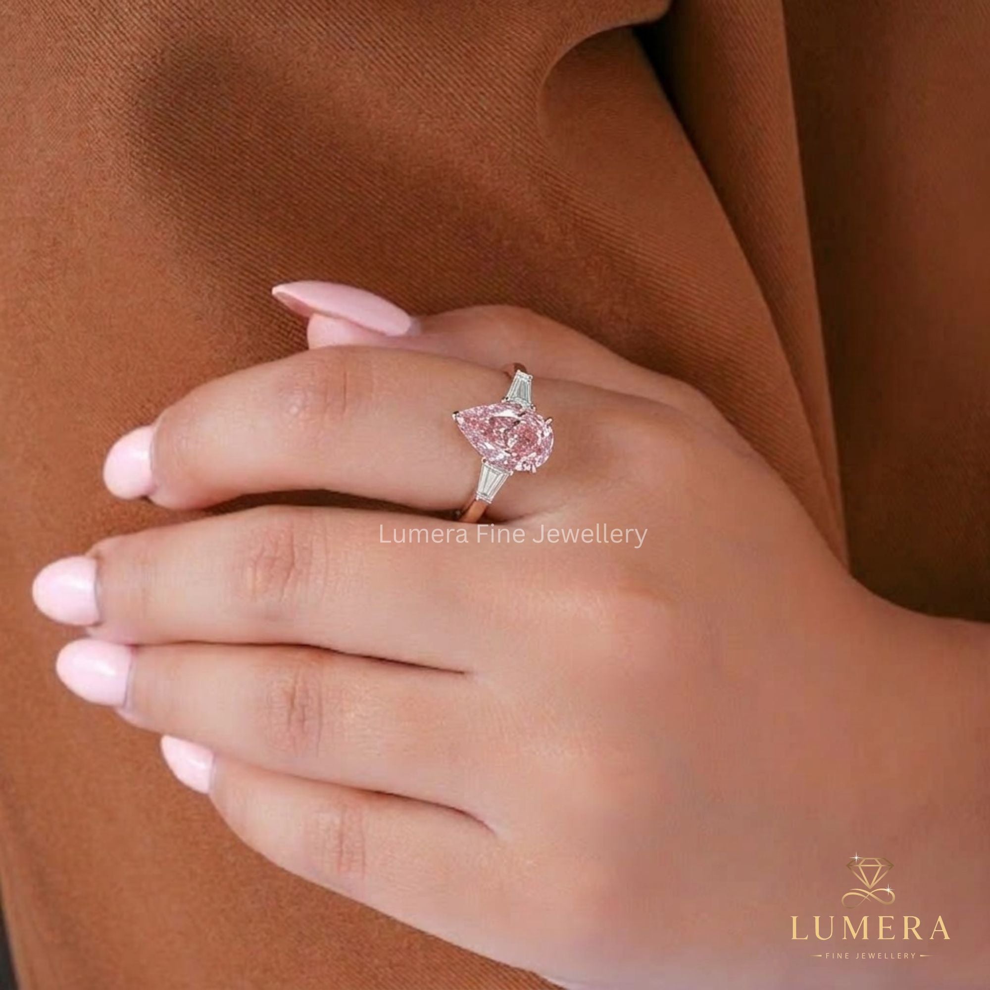 Almond diamond engagement ring featuring a color stone ring.
