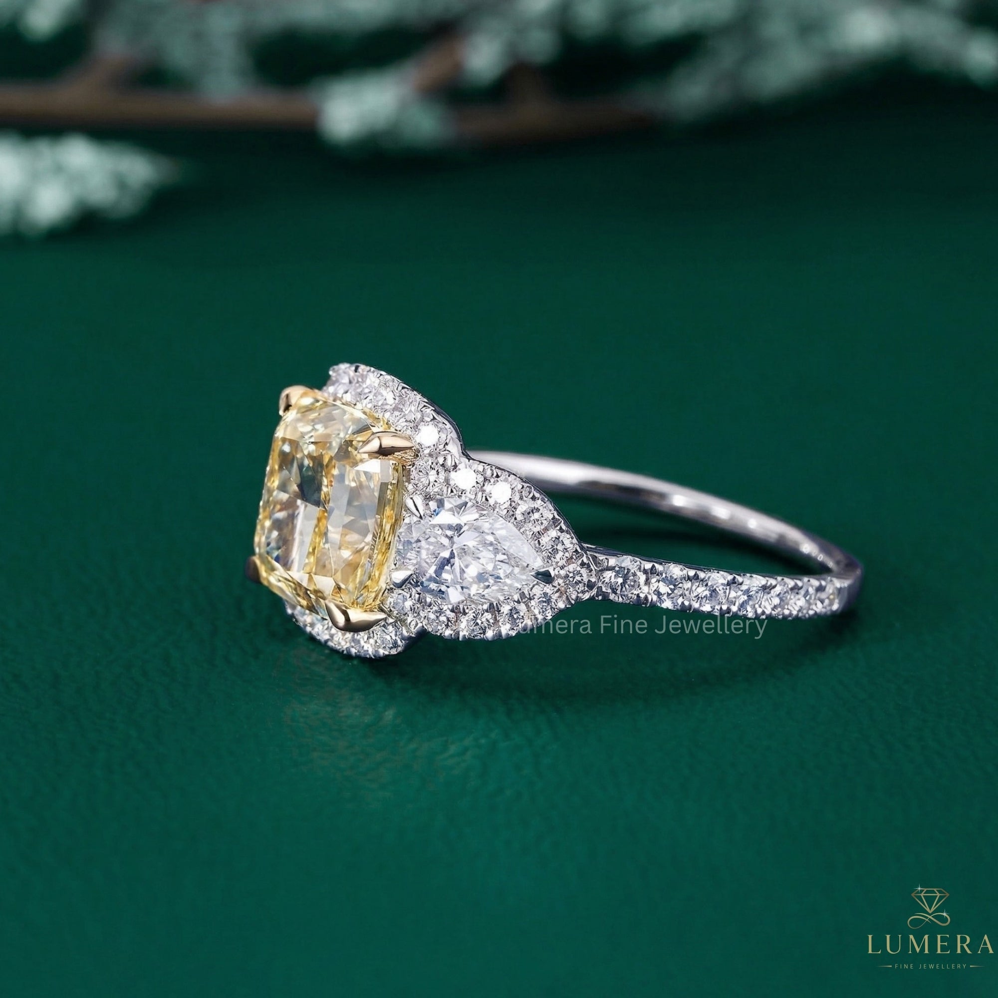 cushion cut halo engagement ring with pear side stone ring.