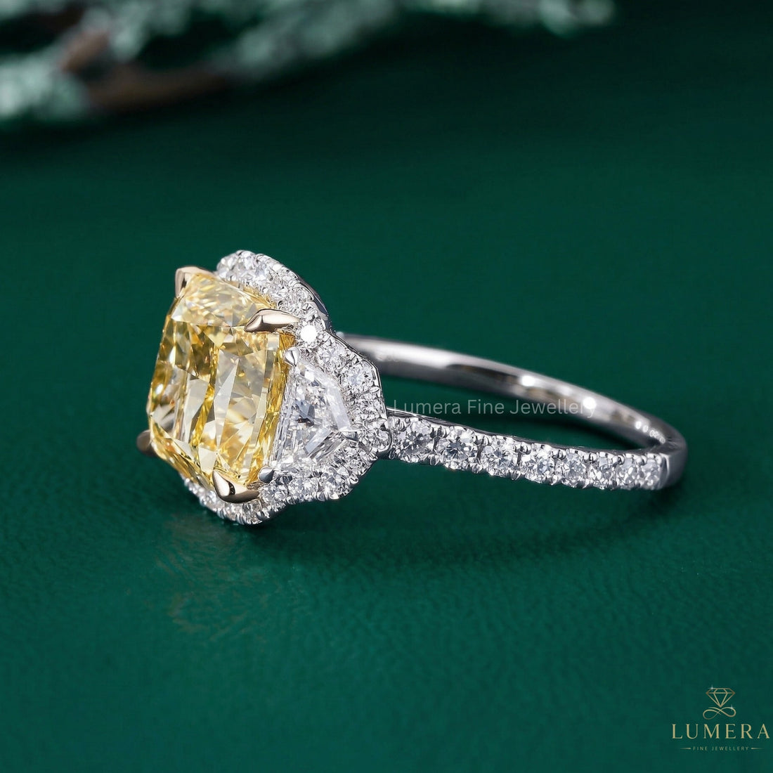 cushion diamond ring with cadillac side stones.