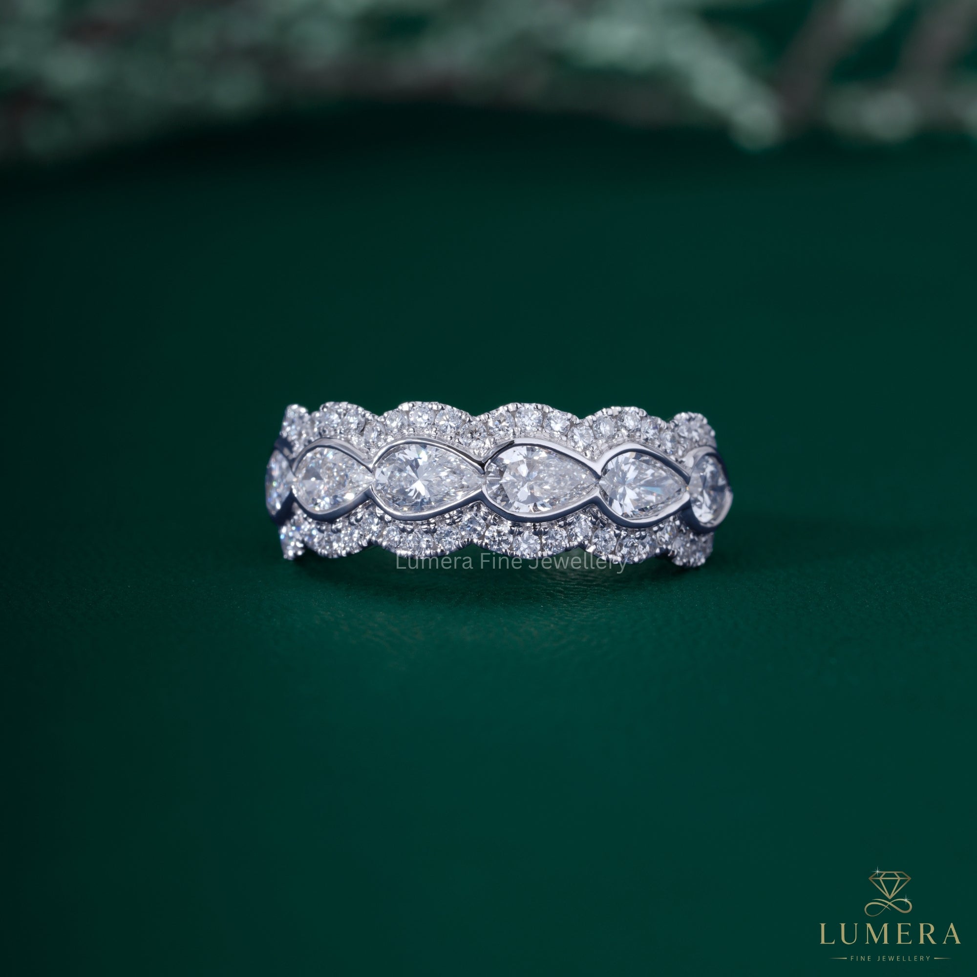 Pear diamond wedding band with bezel setting band.