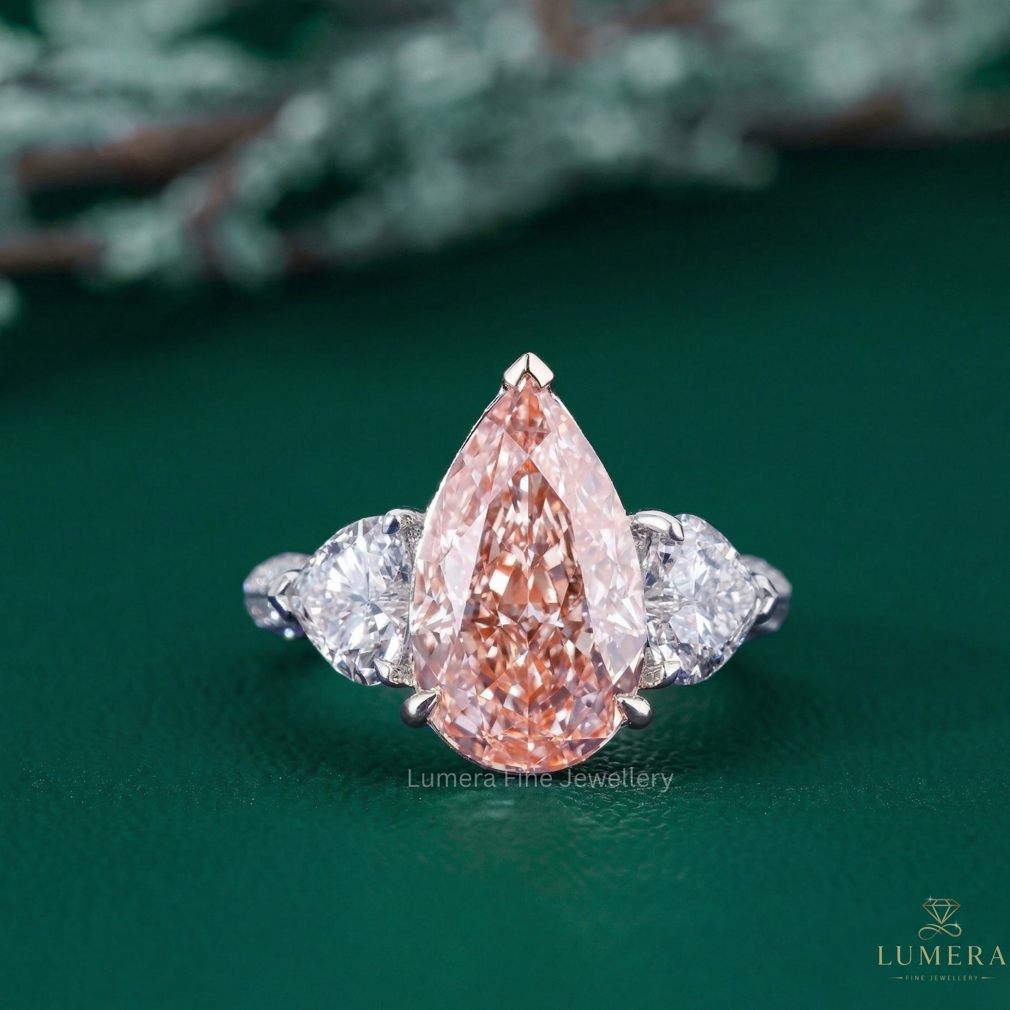 pink pear diamond ring with three stone diamond ring.