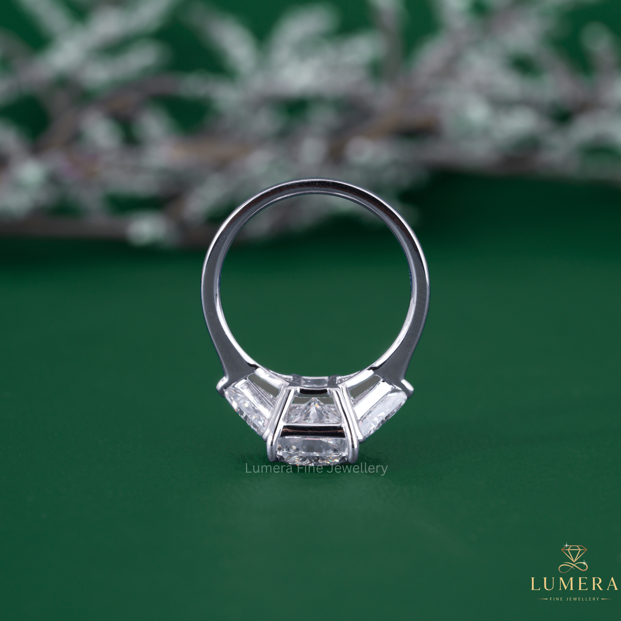 Three stone ring with trilliant cut side stone.