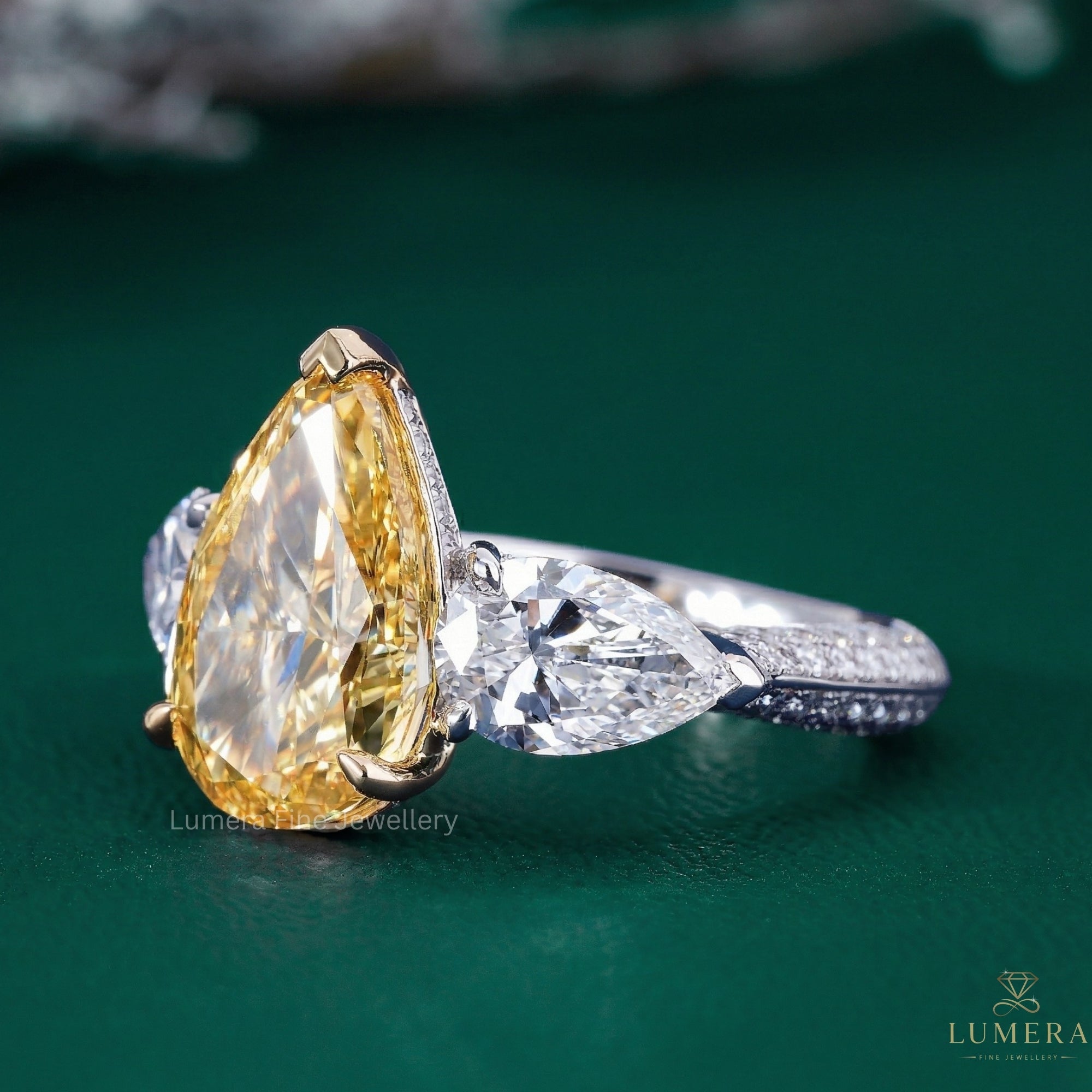 pear diamond engagement ring with pear side stones