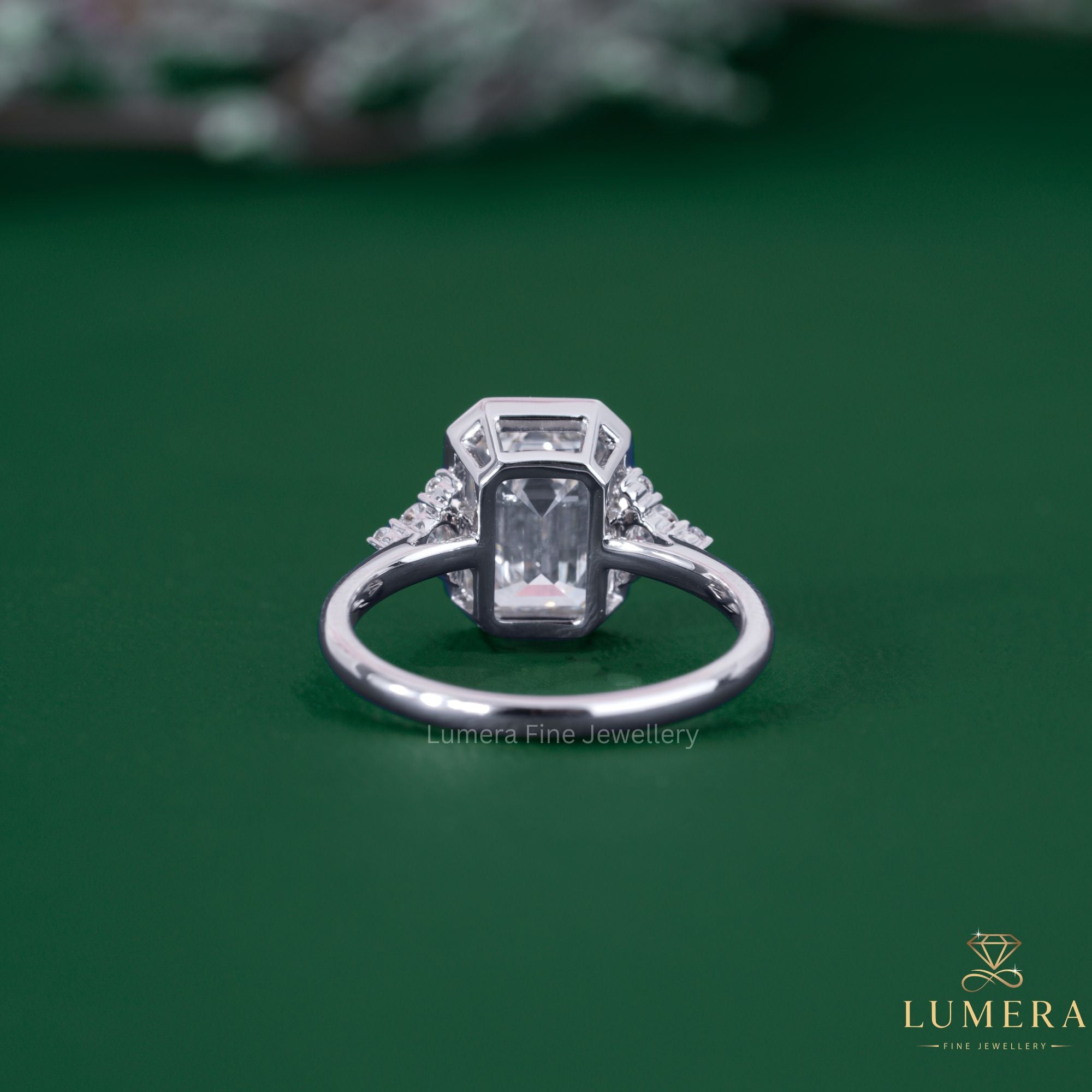 Bezel engagement ring with emerald engagement ring.