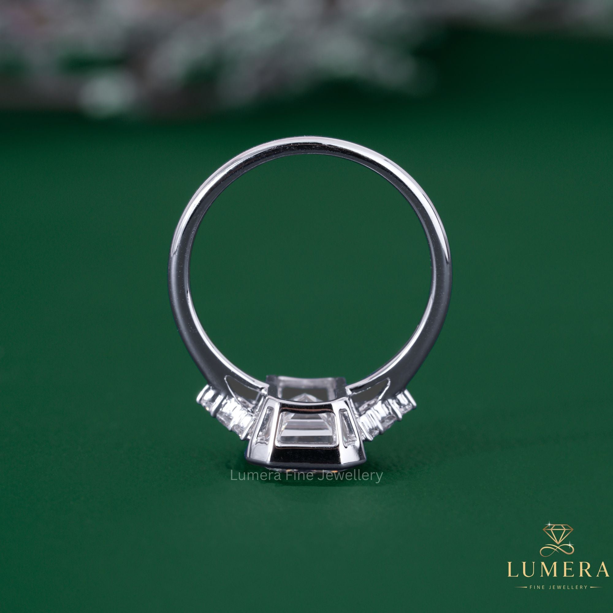 Emerald cut bezel setting with cathedral setting ring