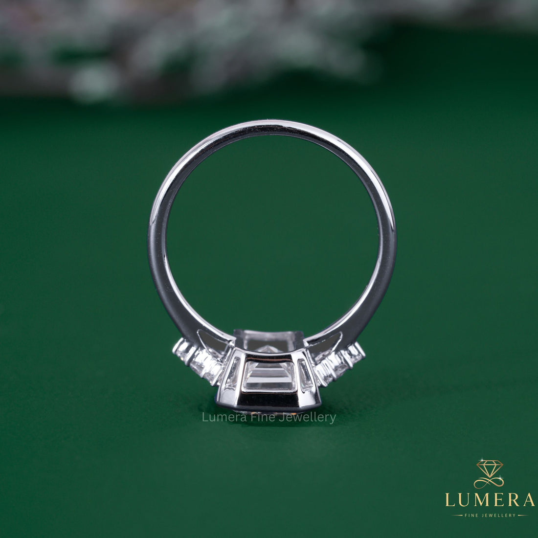 Emerald cut bezel setting with cathedral setting ring
