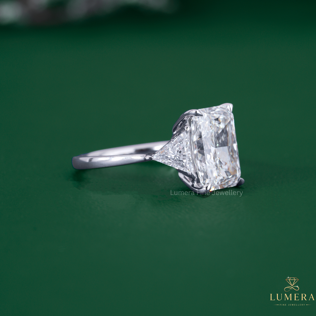 Radiant engagement ring with tapered shank ring.