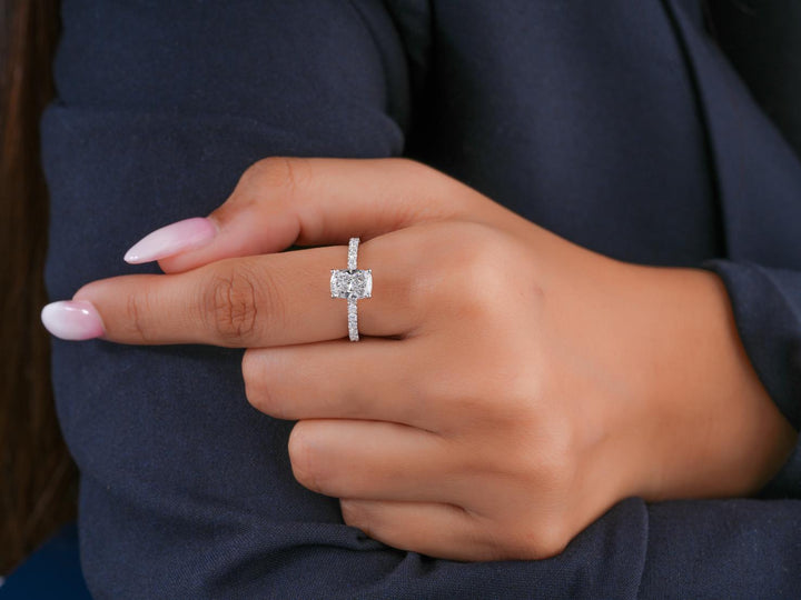 elongated cushion cut engagement ring on pave setting ring.
