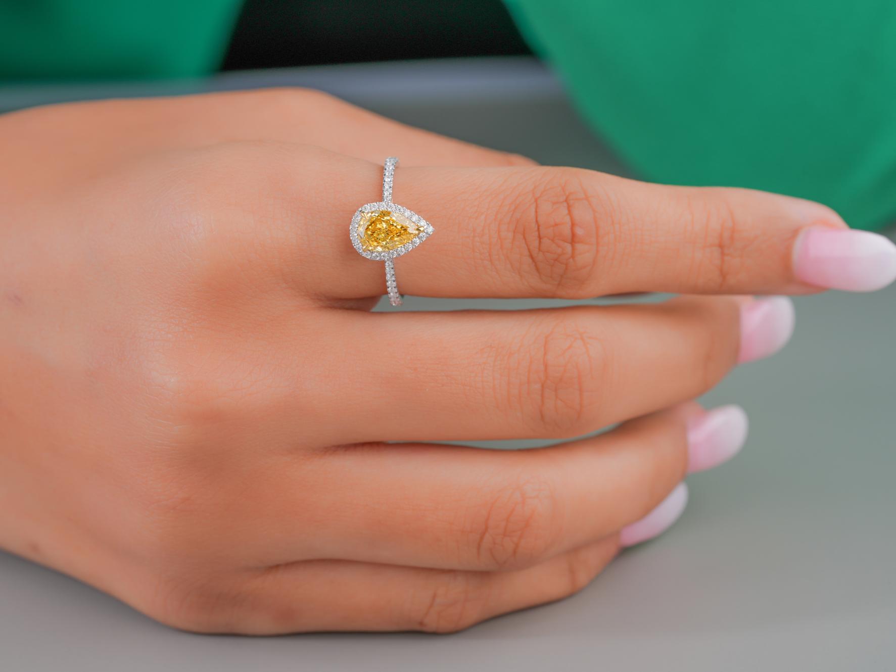 pear shape halo engagement ring with V prong setting.
