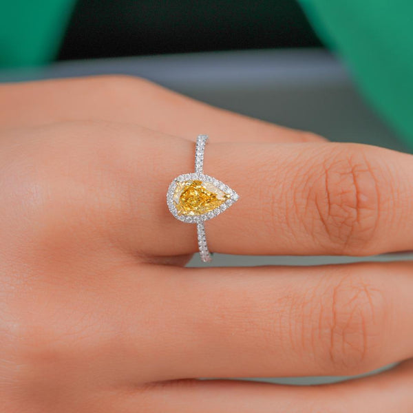 pear shape halo engagement ring with V prong setting.
