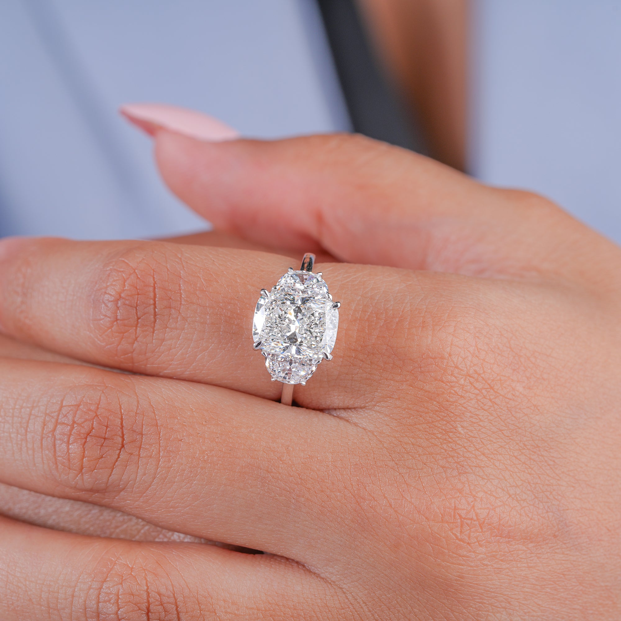 cushion cut diamond ring in trilogy diamond ring style.
