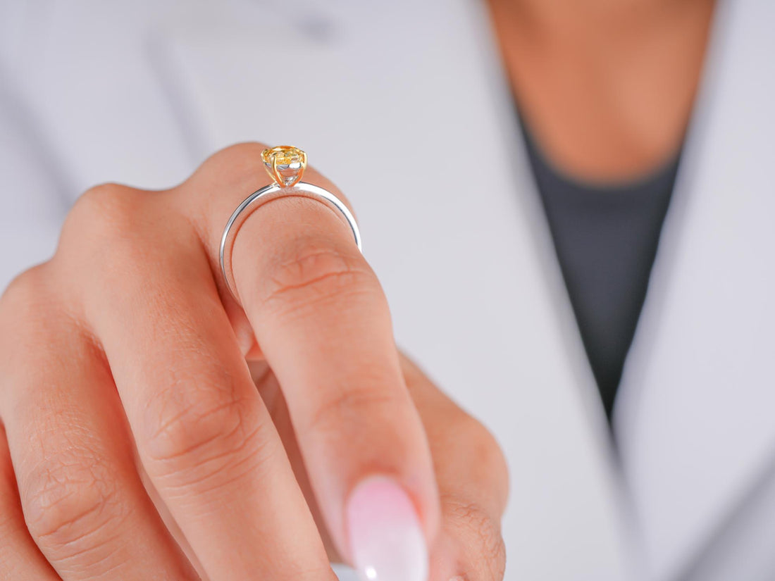 Yellow oval cut diamond ring in oval engagement ring style.