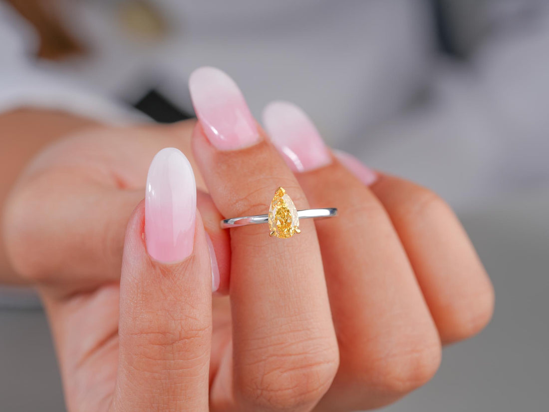 pear engagement ring with yellow stone ring.
