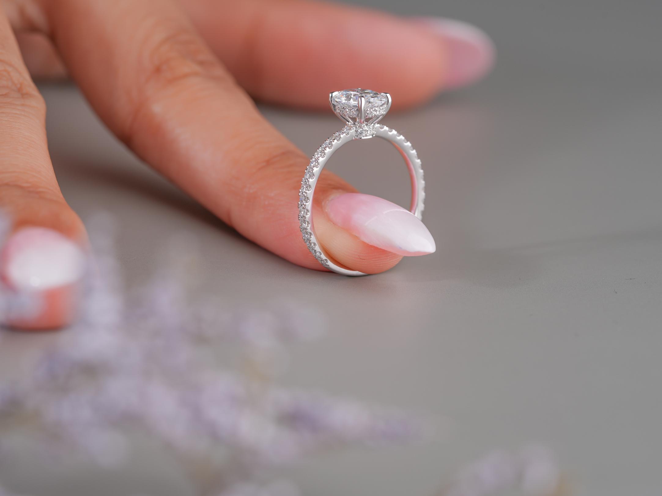 oval diamond engagement ring on pave set band ring.

