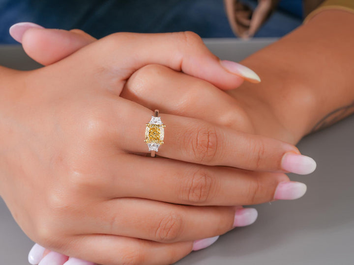 cushion trapezoid side stones with three stone engagement ring.

